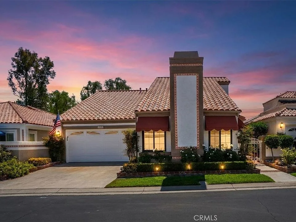 Front exterior of 28391 Borgona at dusk